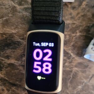 Fitbit Charge 5 with charger and 3 straps.